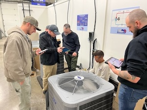 Technicians working on HVAC equipment in a laboratory setting